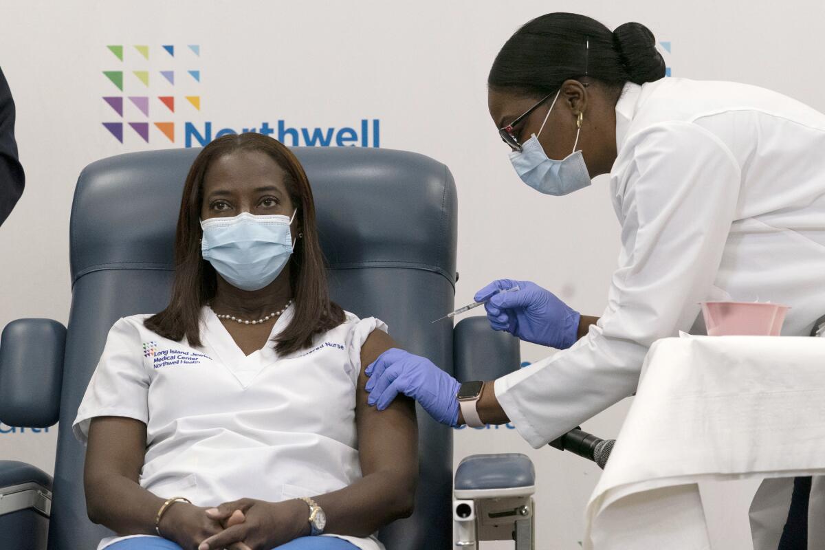 Woman receiving the Pfizer-BioNTech COVID-19 vaccine