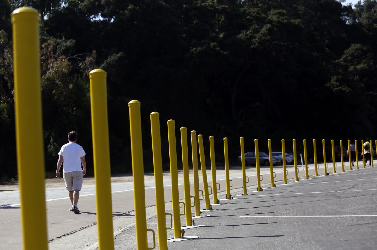 A man begins his walk south of the Rose Bowl stadium, near the corner of West Drive and Seco Street in Pasadena.