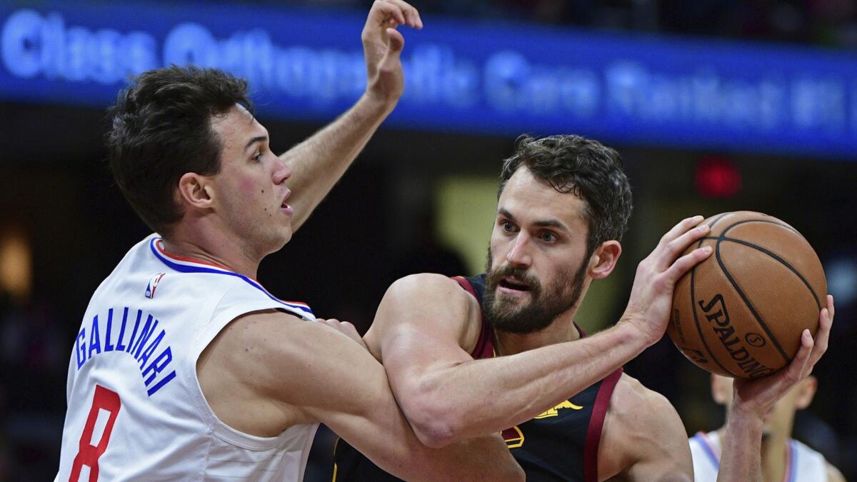 Clippers forward Danilo Gallinari tries to hold his ground as Cavaliers forward Kevin Love looks to score inside.
