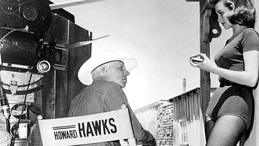 Director Howard Hawks with actress Angie Dickinson on the set of "Rio Bravo," 1959.