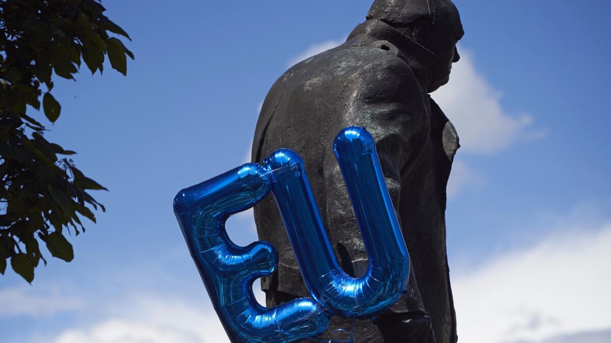 An EU balloon is attached to the Winston Churchill statue in Parliament Square in London as protesters took part in a March for Europe on Saturday.