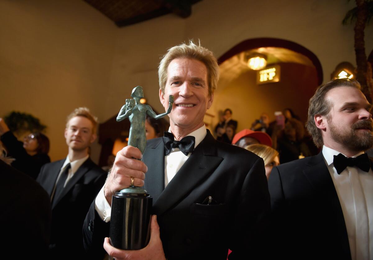 Actor Matthew Modine, holding a Screen Actors Guild Award.