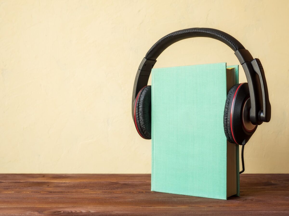 Book upright on table seeming to wear headphones