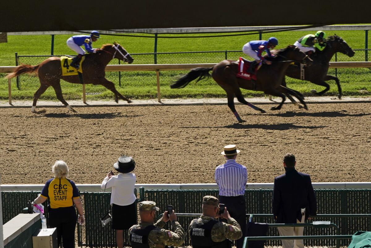 Guests watch a race before the 146th running of the Kentucky Derby at Churchill Downs on Saturday.