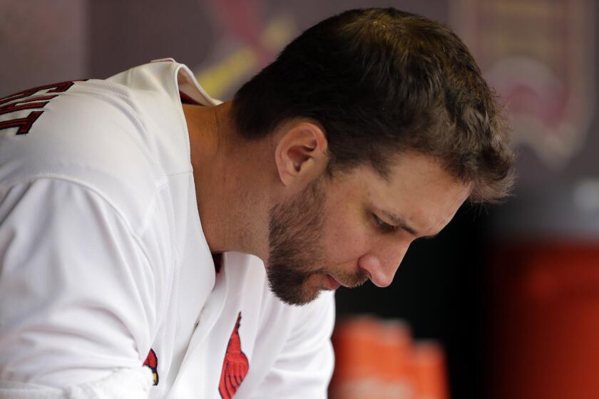 St. Louis Cardinals starter Adam Wainwright sits in the dugout during a game against the Milwaukee Brewers on April 13, 2015.