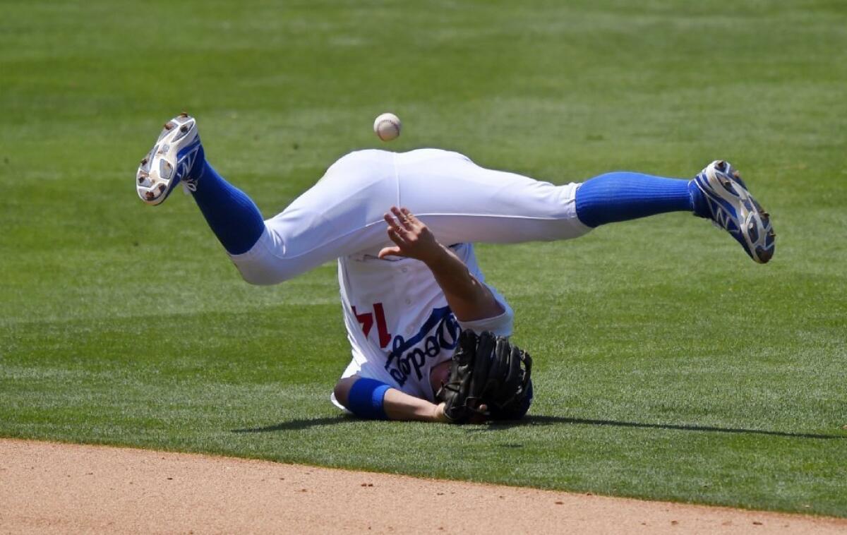 Dodgers shortstop Enrique Hernandez makes an unsuccesful attempt to flip the ball to second base for a force out against the Mets.