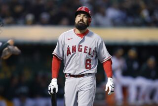 Los Angeles Angels third baseman Anthony Rendon (6) walks to the dugout against the Oakland Athletics.