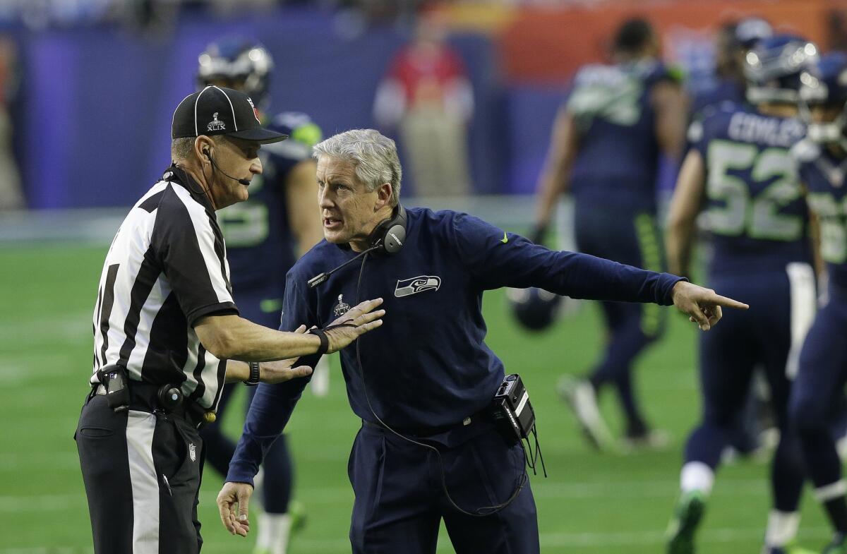 Seahawks Coach Pete Carroll argues with line judge Mark Perlman in the first quarter.
