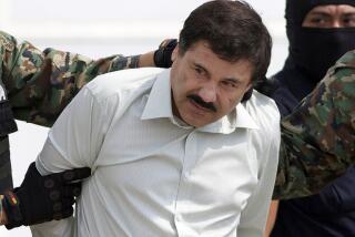 FILE - In this Feb. 22, 2014 file photo, Joaquin "El Chapo" Guzman, the head of Mexico's Sinaloa Cartel, is escorted to a helicopter in Mexico City following his capture in the beach resort town of Mazatlan, Mexico. Mexican President Andrés Manuel López Obrador said on Wednesday, Jan. 18 2023 that the government will analyze El Chapo's request to be returned to Mexico to carry out his life prison sentence. (AP Photo/Eduardo Verdugo, File)