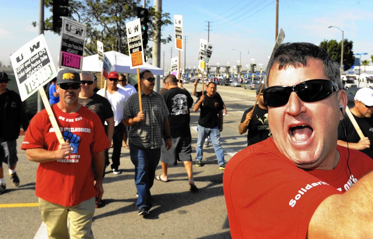 Workers at nine refineries — including Tesoro Corp.’s Carson facility, above — remained on strike for a second day Monday amid a standoff between the United Steelworkers union and oil companies over contract negotiations.