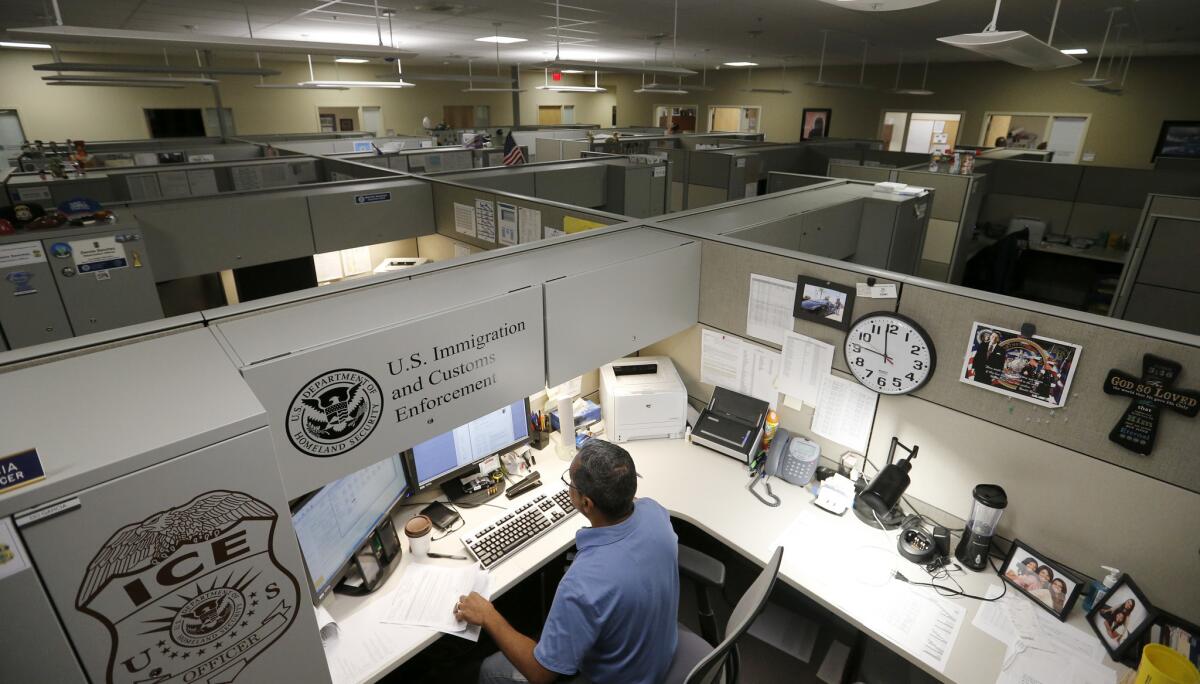 Immigration and Customs Enforcement personnel work at the Pacific Enforcement Response Center in Laguna Niguel in 2017. The facility is an ICE hub from which agents send out detainer requests to authorities.