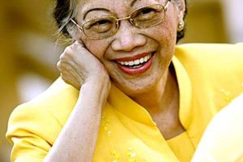 Aquino, in her signature yellow, attends Mass in 2008 to commemorate the 25th anniversary of her husband's slaying, which sparked a nonviolent uprising that toppled dictator Ferdinand Marcos and brought her to power.