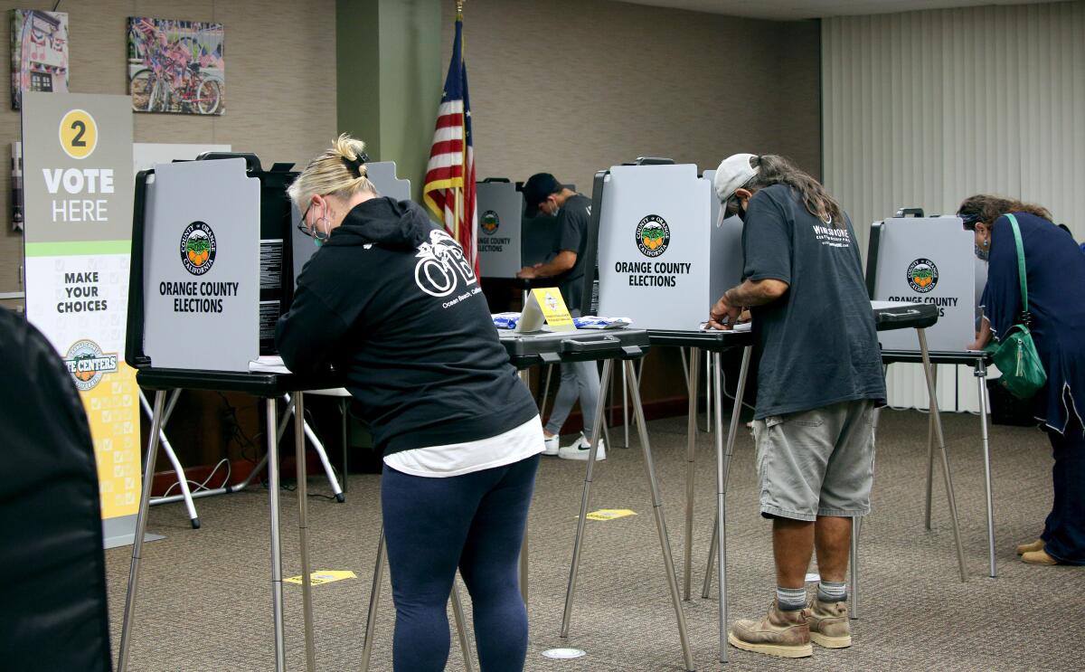 Voters cast their ballot at the Civic Center polling location, in Huntington Beach in November 2020.