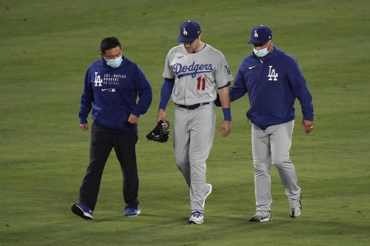 The Dodgers' AJ Pollock (11) leaves the game after he sustained an injury during the sixth inning May 7, 2021.