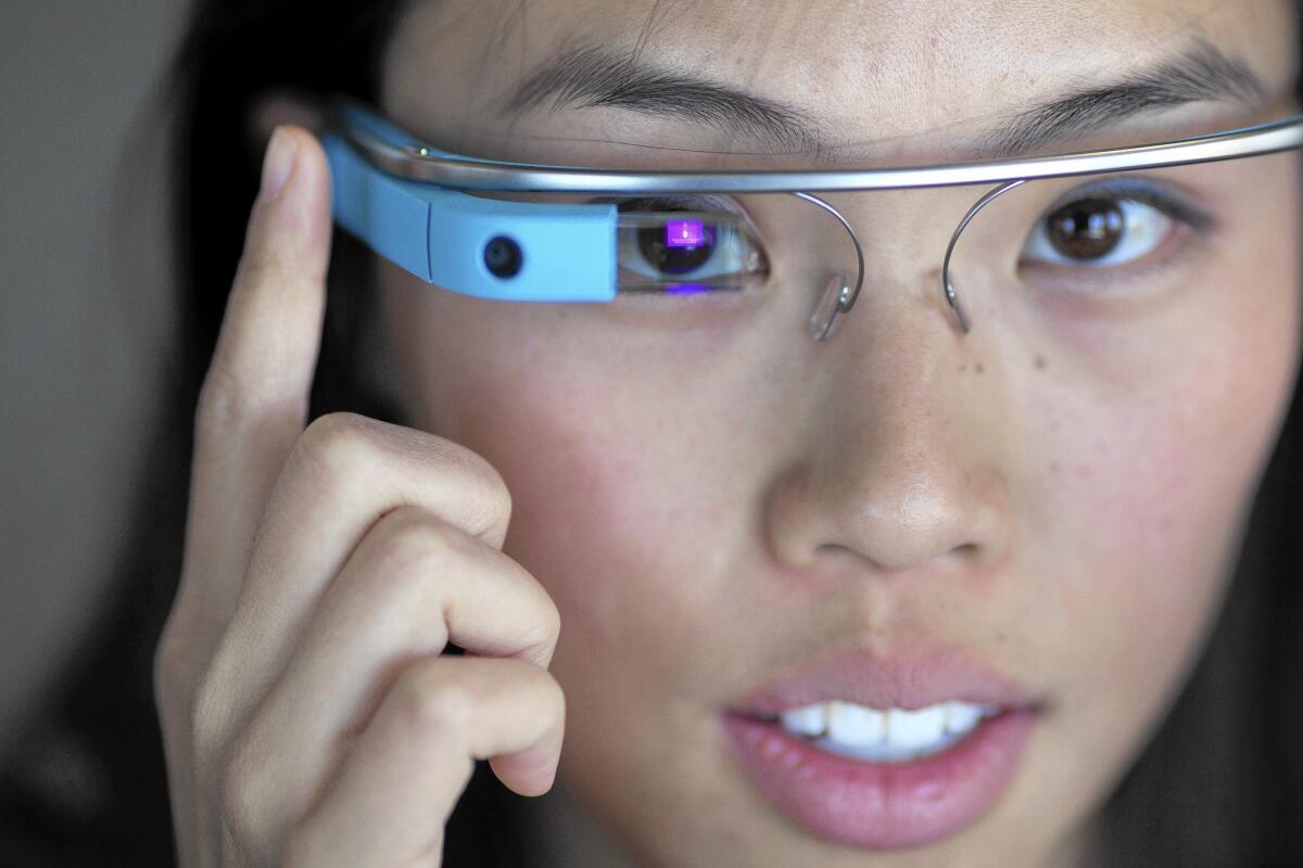 Erica Pang swipes the touch bar on her Google Glass device.
