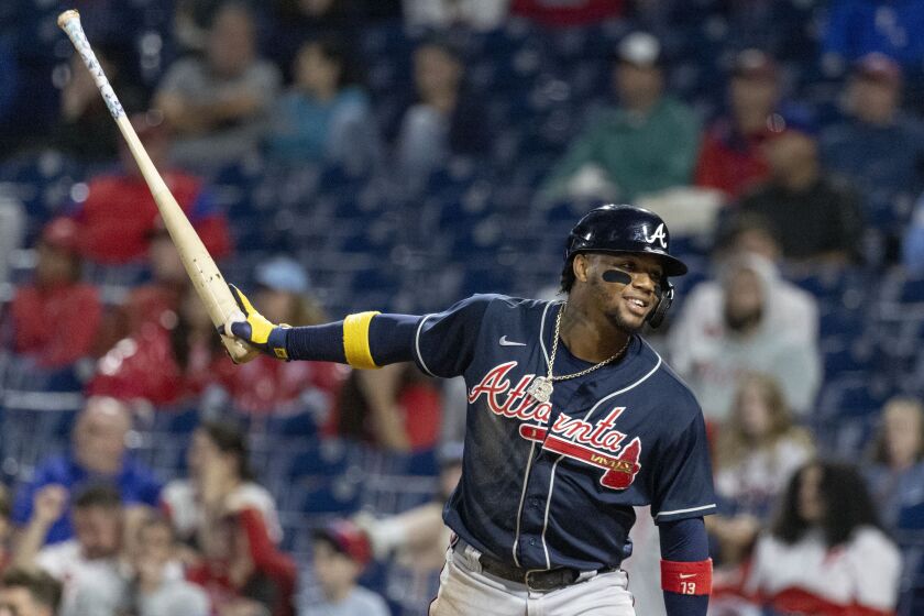 Atlanta Braves's Ronald Acuna Jr. celebrates after scoring on an RBI single by Michael Harris II during the 11th inning of a baseball game against the Philadelphia Phillies, Sunday, Sept. 25, 2022, in Philadelphia. (AP Photo/Laurence Kesterson)