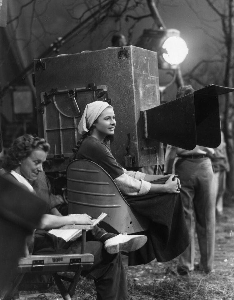 1948: Actress Ingrid Bergman sits next to the camera during a break in filming on the set of director Victor Fleming's film "Joan of Arc."