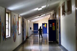 PASADENA, CALIFORNIA: A child walks the hallway while attending a LEARNs summer program at Washington Elementary School in Pasadena on Friday, July 9, 2021. In the wake of pandemic-related learning loss, districts across California had high hopes for Summer programs that might help catch kids up-and there's unprecedented state funding to do so. (Christina House / Los Angeles Times)
