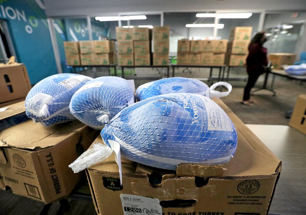 Frozen turkeys await pick-up at the Santa Ana Boys and Girl's Club on Tuesday.