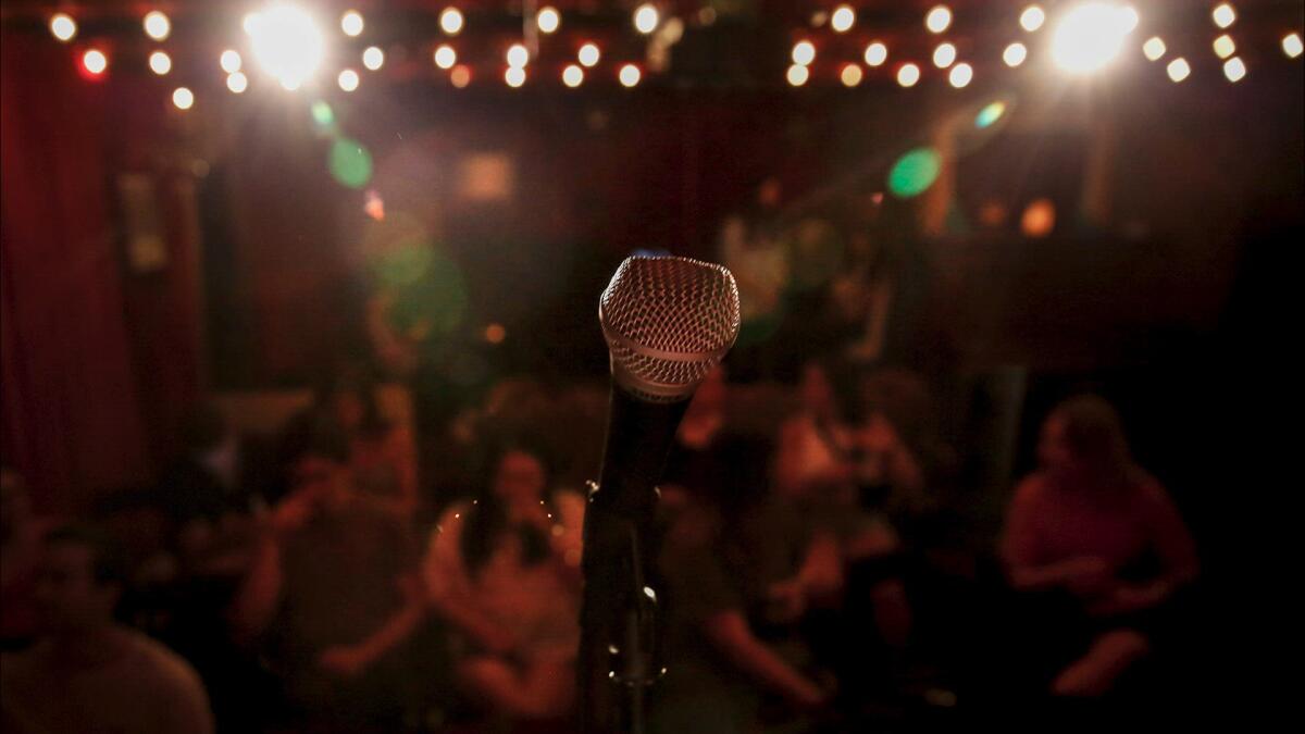 a microphone at the front of a stage under lights