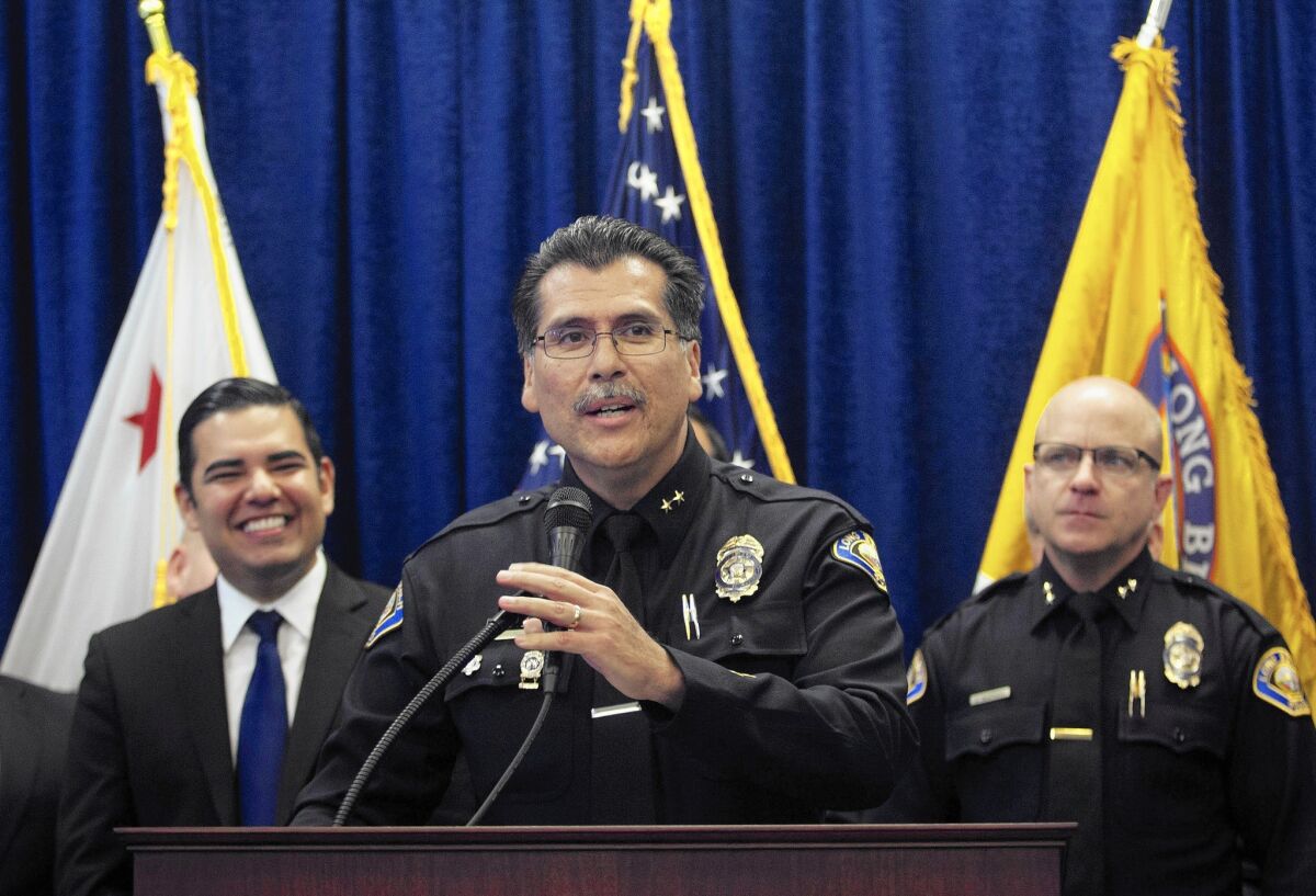 “I have 100% confidence that Chief Luna will lead our department with integrity, strength and commitment to community policing,” Long Beach Mayor Robert Garcia, left, said as he announced the appointment of Robert Luna, center, to lead the city’s Police Department.