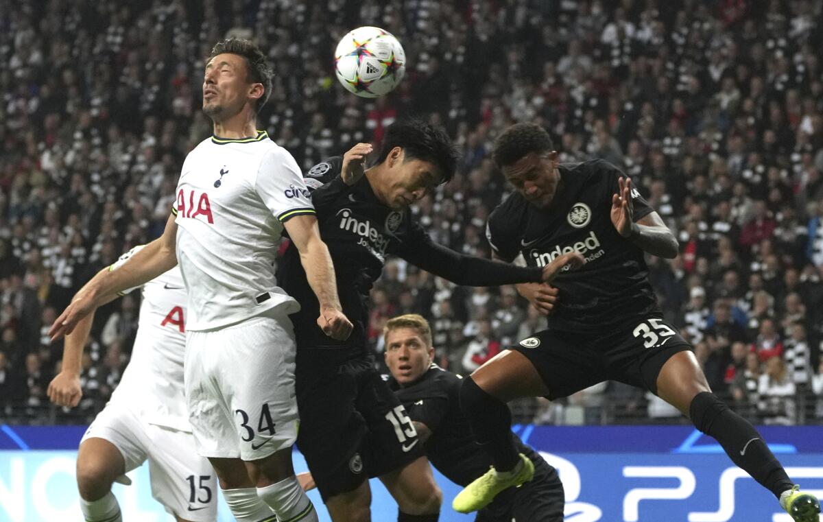Tottenham's Clement Lenglet, left, challenges for the ball with Frankfurt's Daichi Kamada during the Champions League Group D soccer match between Eintracht Frankfurt and Tottenham Hotspurs in Frankfurt, Germany, Tuesday, Oct.4, 2022. (AP Photo/Michael Probst)