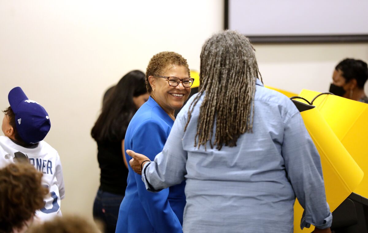 Mayoral candidate Karen Bass chats with a poll worker on Tuesday.