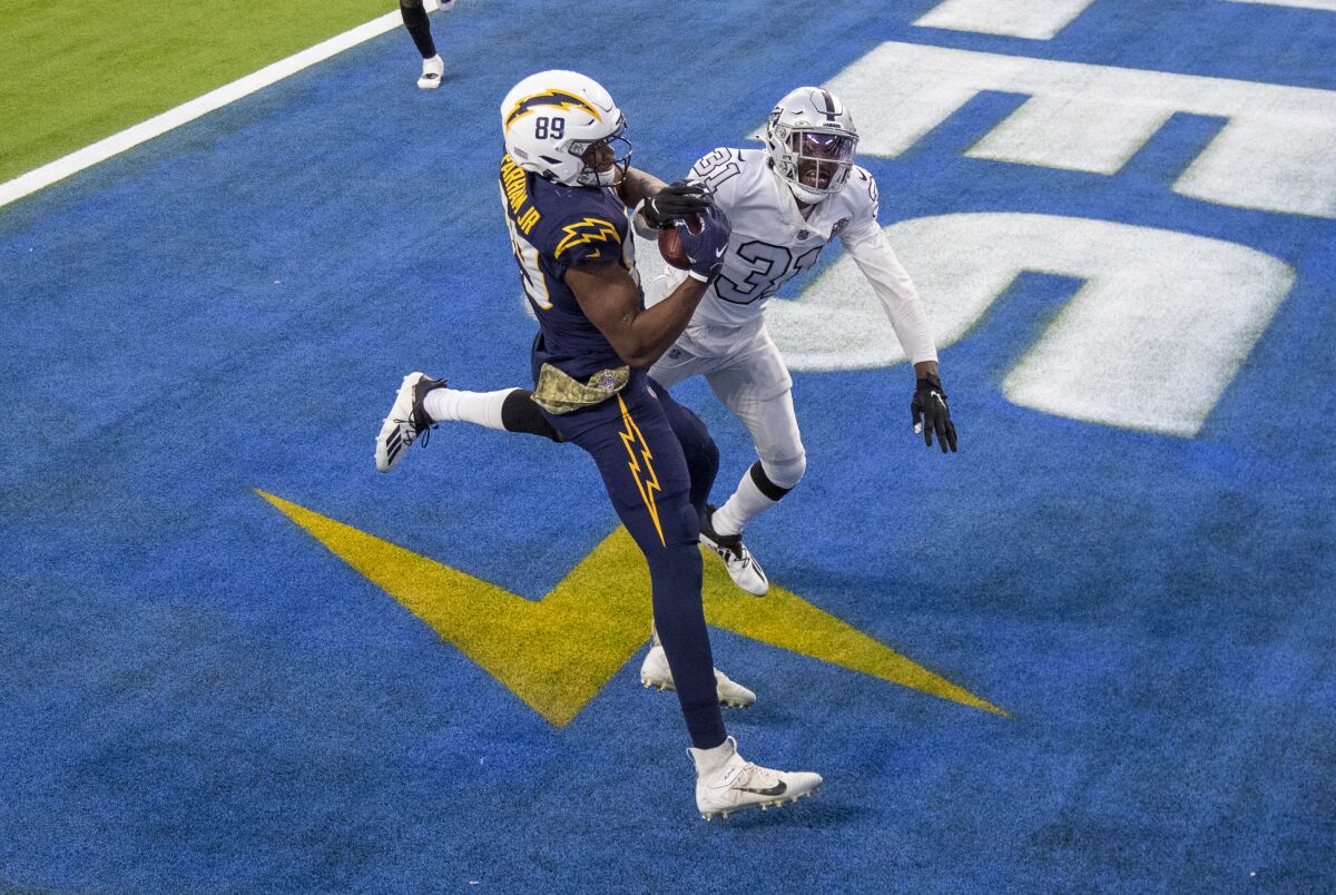 The Chargers' Donald Parham appears to make the winning catch against the Raiders' Isaiah Johnson, but he couldn't hang on.