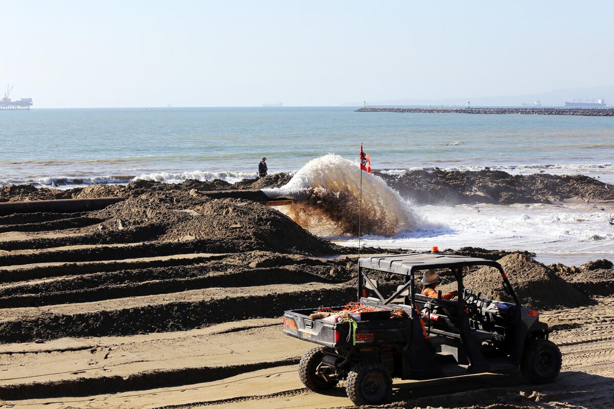 Sand is pumped from a ship two miles offshore in Sunset Beach as part of the sand replenishment project.