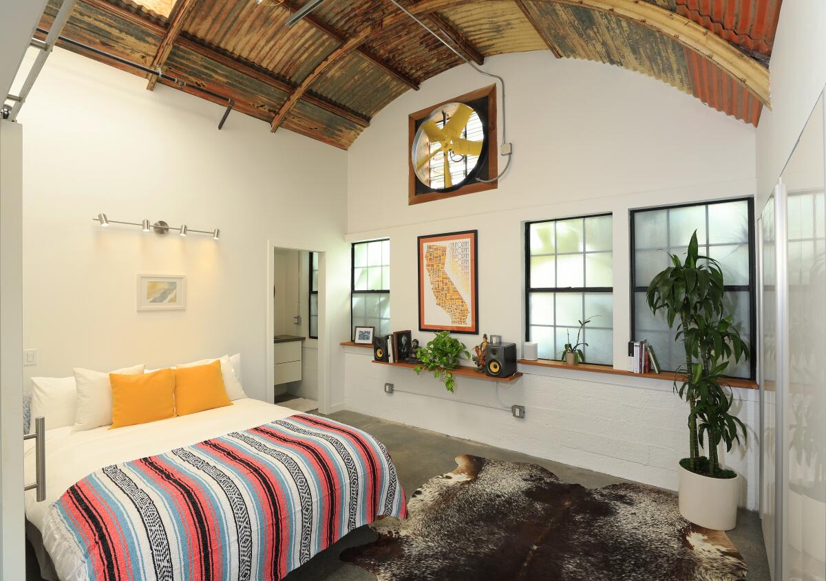 T The home’s second bedroom includes a fan from the original Belly Up Quonset hut, mounted into the wall.