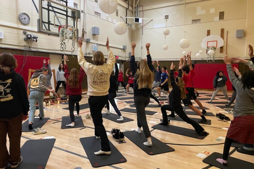 Students participate in yoga-like exercises as part of the breathwork session at La Jolla High School.