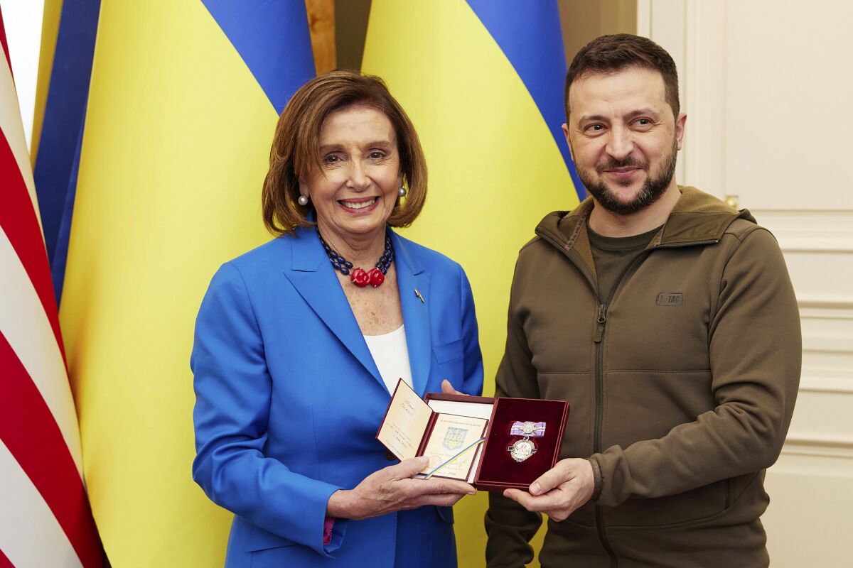 In this image released by the Ukrainian Presidential Press Office on Sunday, May 1, 2022, Ukrainian President Volodymyr Zelenskyy, right, awards the Order of Princess Olga, the third grade, to U.S. Speaker of the House Nancy Pelosi in Kyiv, Ukraine, Saturday, April 30, 2022. Pelosi, second in line to the presidency after the vice president, is the highest-ranking American leader to visit Ukraine since the start of the war, and her visit marks a major show of continuing support for the country's struggle against Russia. (Ukrainian Presidential Press Office via AP)