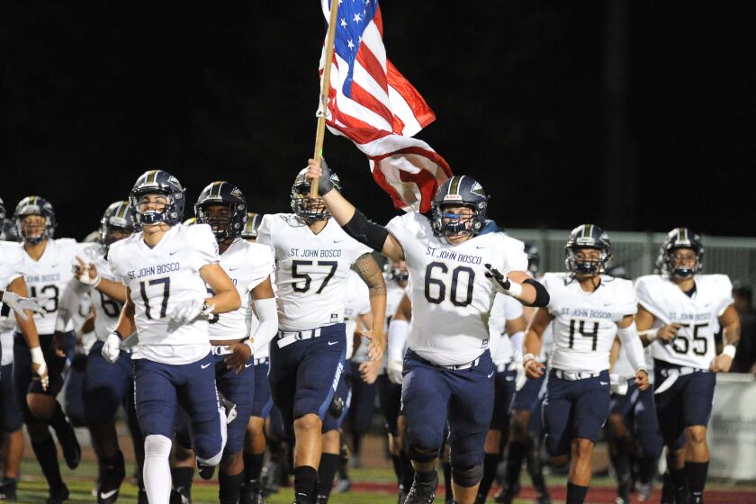 St. John Bosco left tackle Drake Metcalf, headed to Stanford, is the one who holds the American flag when he leads team out for action. He'll hold the flag one last time on Saturday in the CIF state championship Open Division bowl game at Cerritos College.