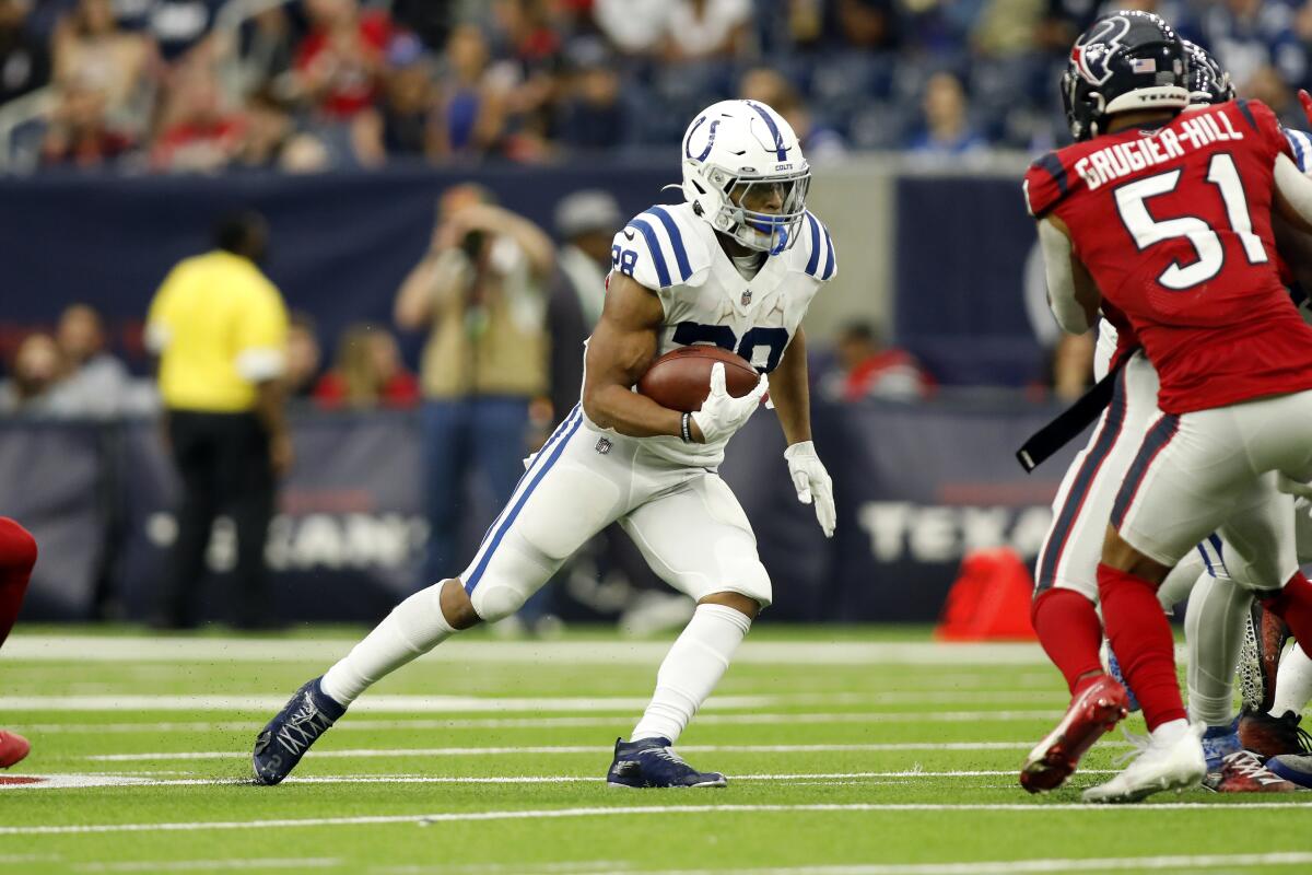 Indianapolis Colts running back Jonathan Taylor carries the ball against the Houston Texans on Sunday.