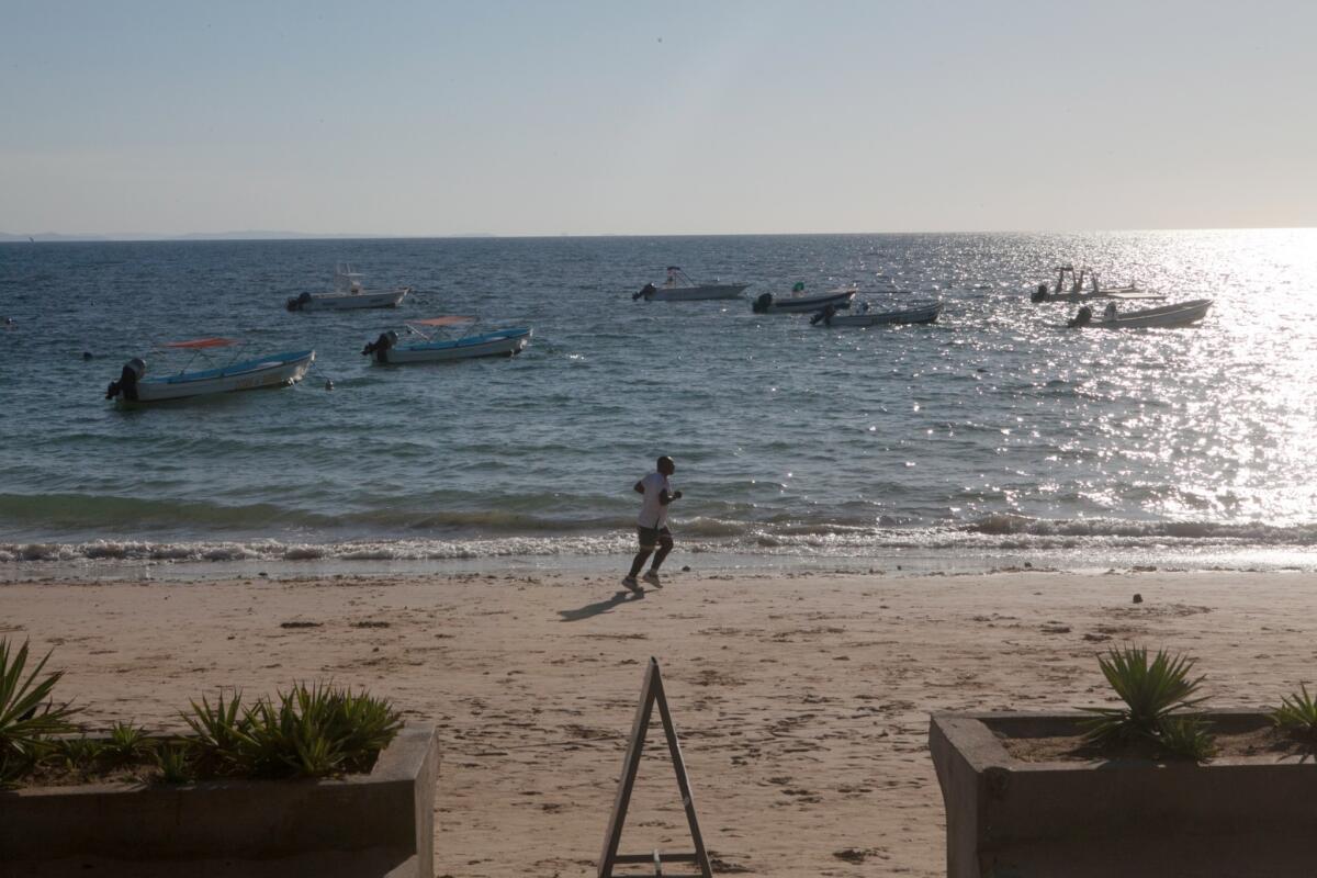 A tourist runs on the beach at Nosy Be in Madagascar.