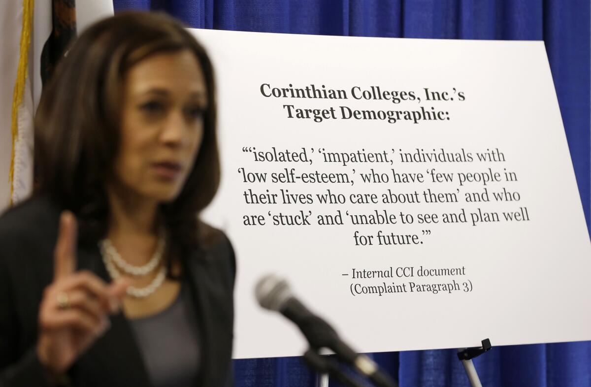 California Atty. Gen. Kamala Harris gestures while standing by a display showing the target demographic of Corinthian Colleges during a news conference last fall. The U.S. Consumer Financial Protection Bureau sued Corinthian on Tuesday, alleging the company lured students with inflated job placement rates and offered "predatory" loans to students.