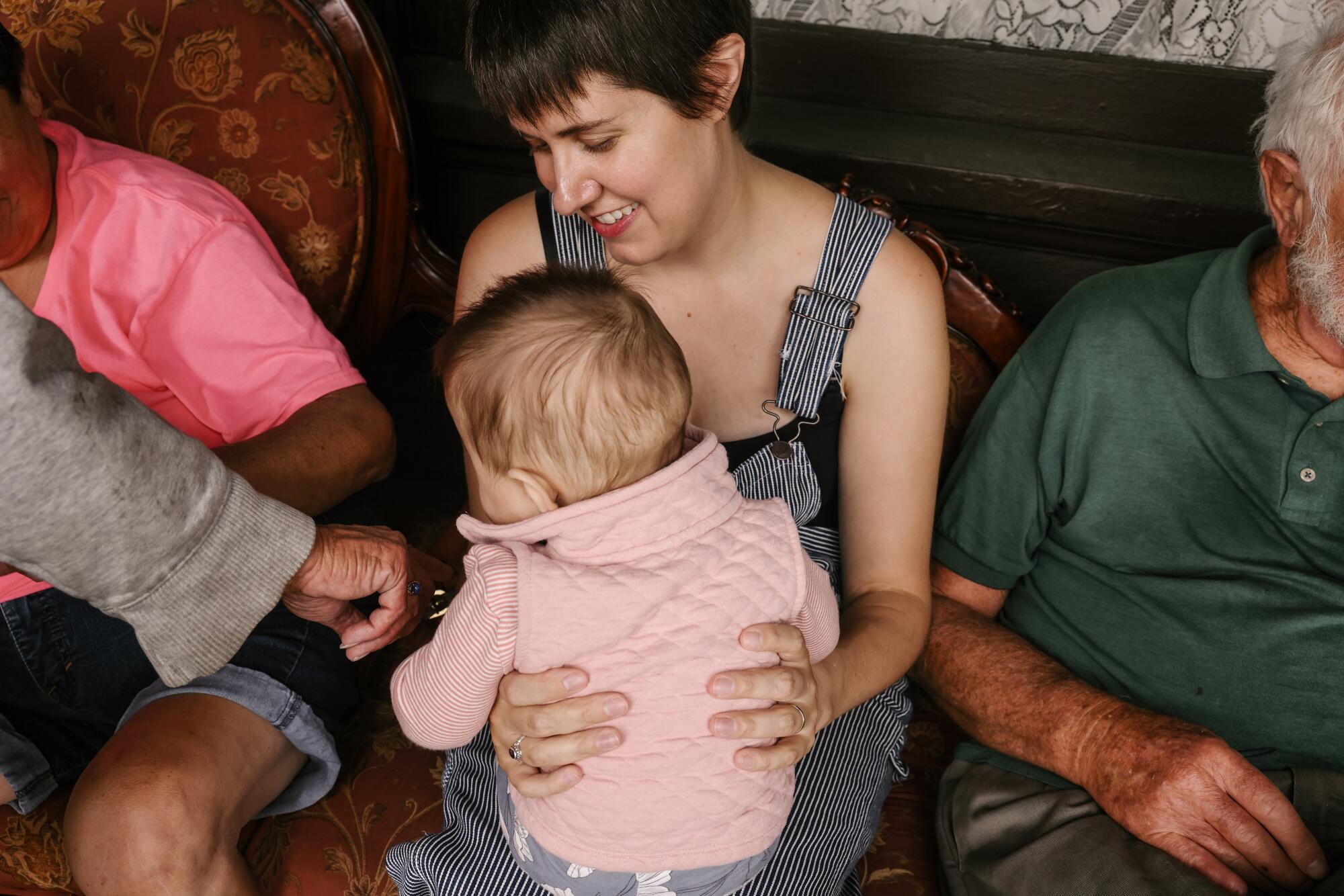 A woman holds her daughter at the Old Brown House
