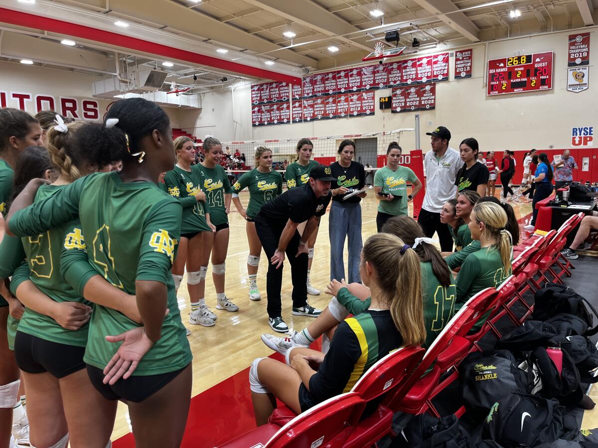 Coach Cam Green talks to Mira Costa volleyball players.