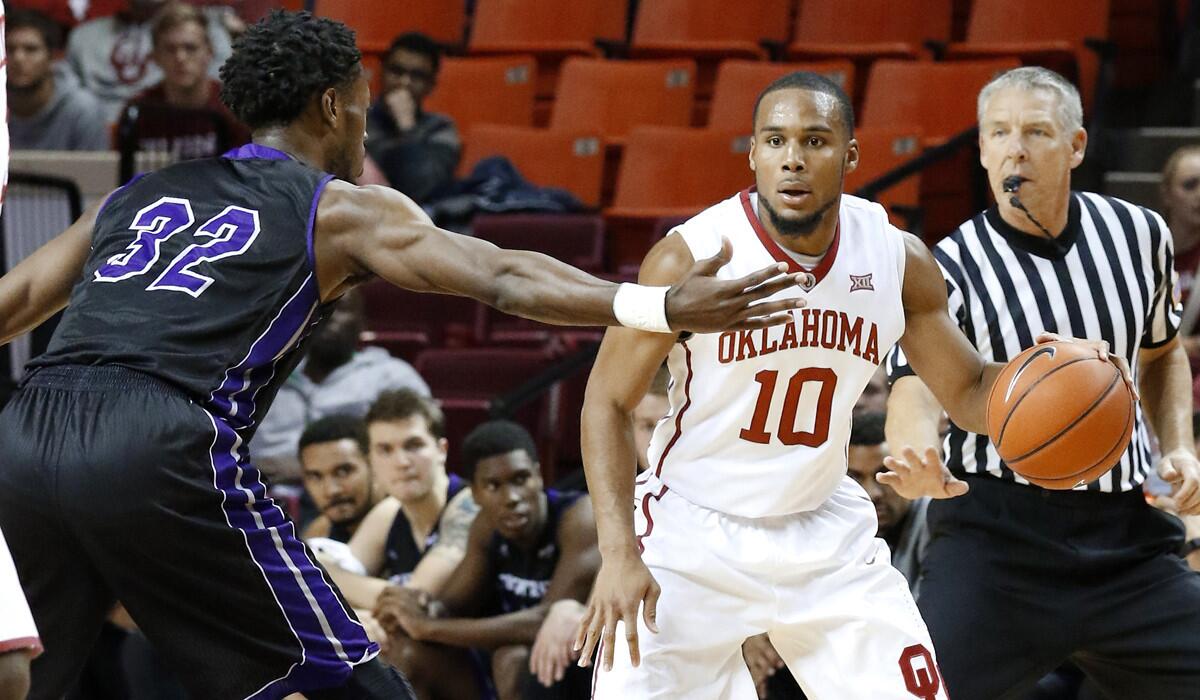 Oklahoma guard Jordan Woodard (10) drives down the court as Central Arkansas guard Derreck Brooks (32) defends during the second half of a game on Thursday.