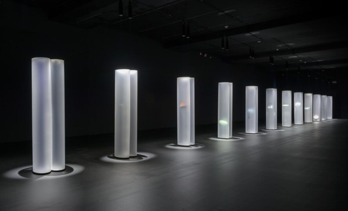 12 towering acrylic columns  make up "Helen Pashgian: Light Invisible"