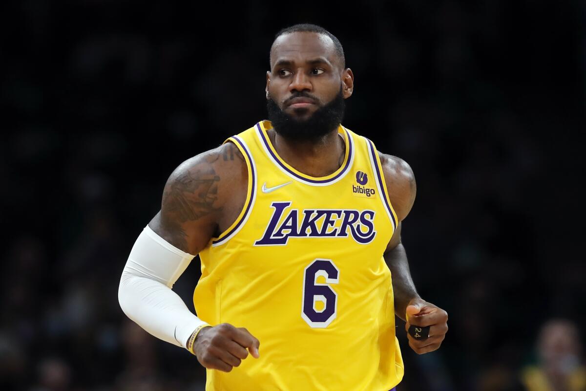 Lakers star LeBron James runs up the court at TD Garden in Boston.