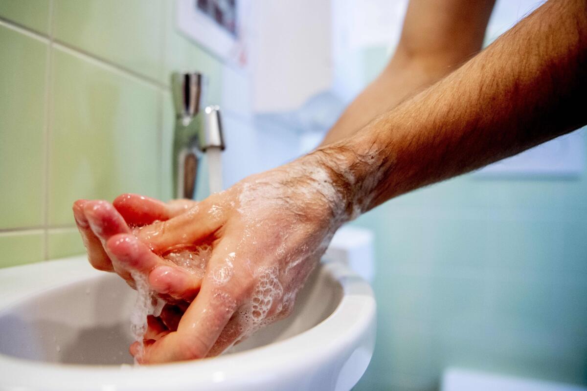 Health worker washing his hands