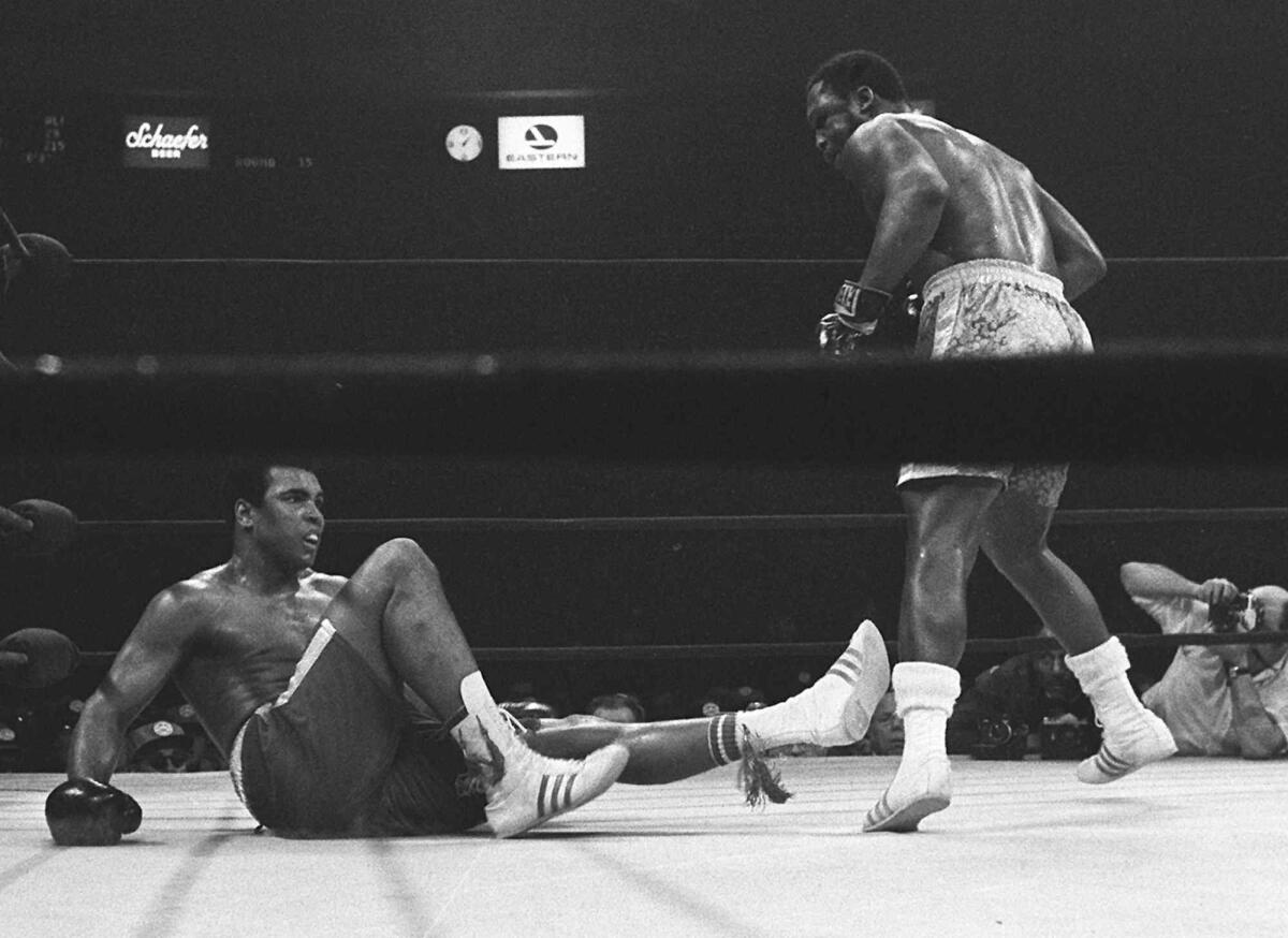 Joe Frazier stands over Muhammad Ali in the 15th round of their boxing match at Madison Square Garden.