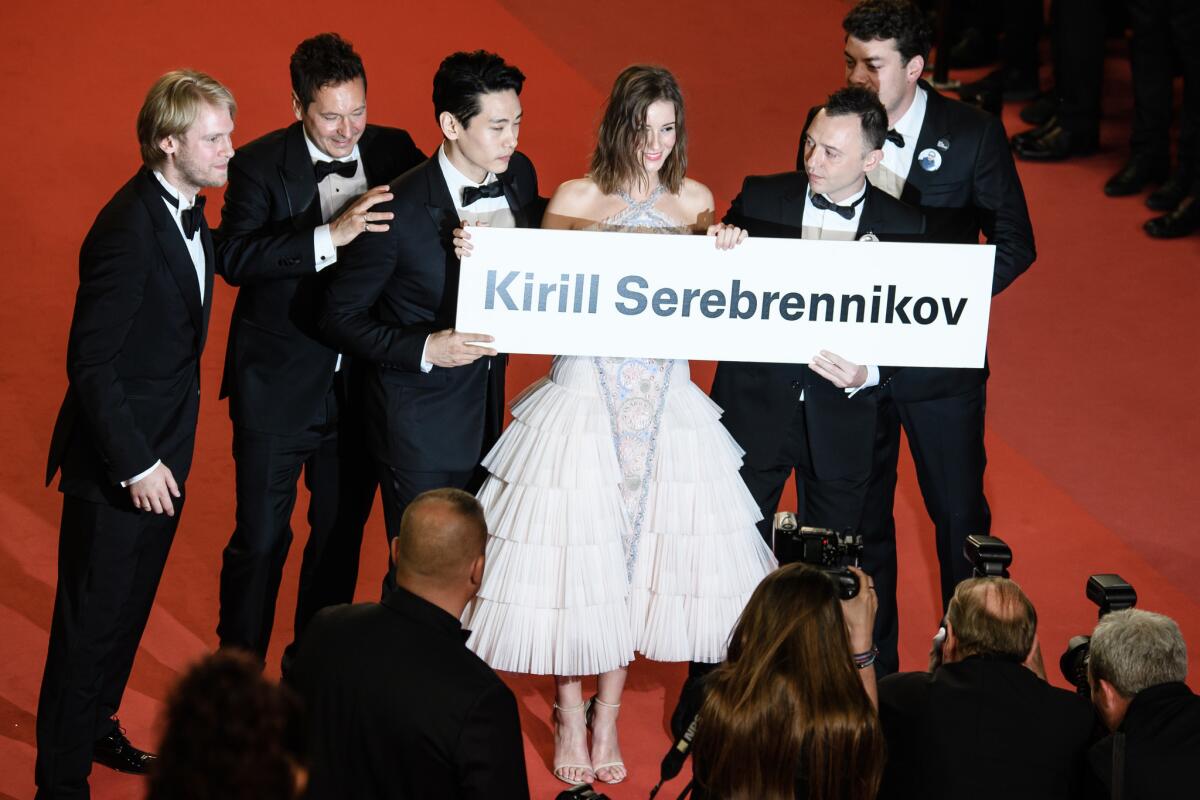 The creative team behind "Leto" holds a sign for embattled Russian director Kirill Serebrenniko.