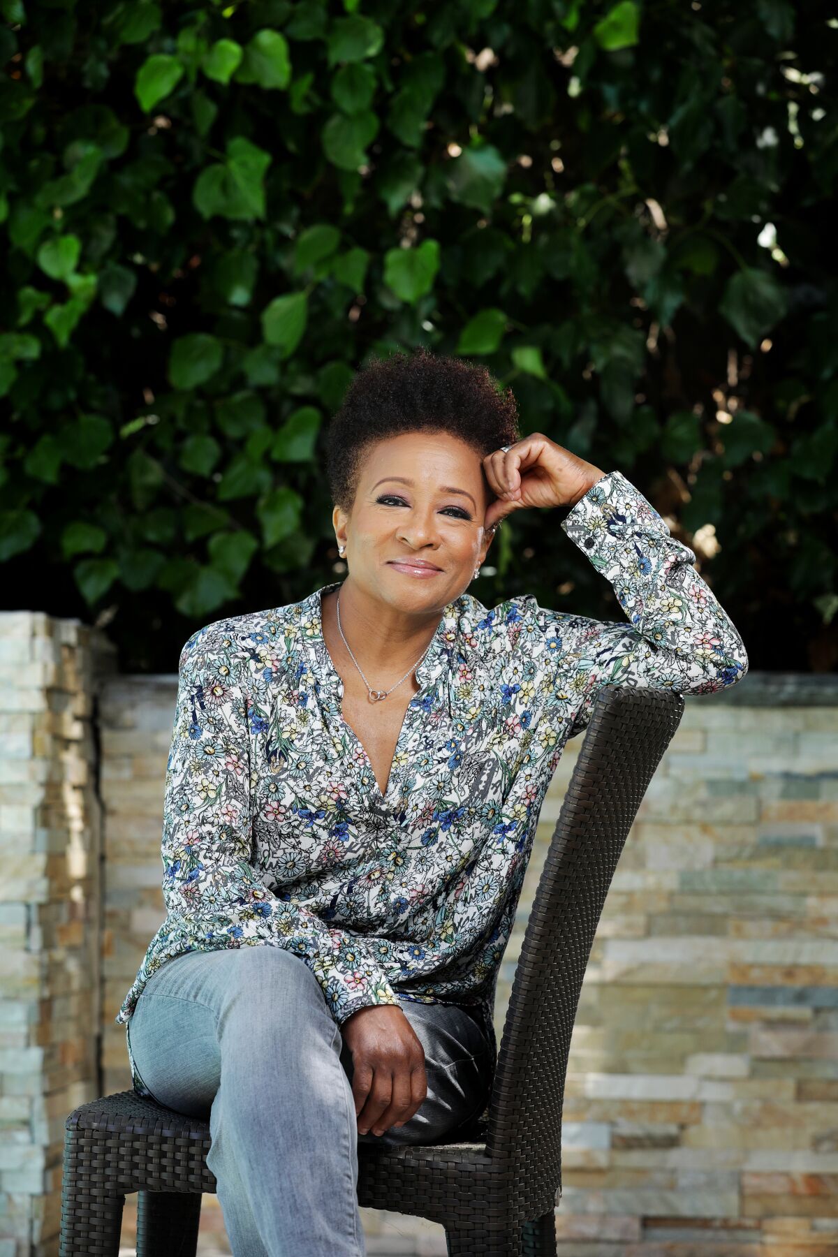 Actress Wanda Sykes of "The Upshaws" sits sideways on a chair with her legs crossed.