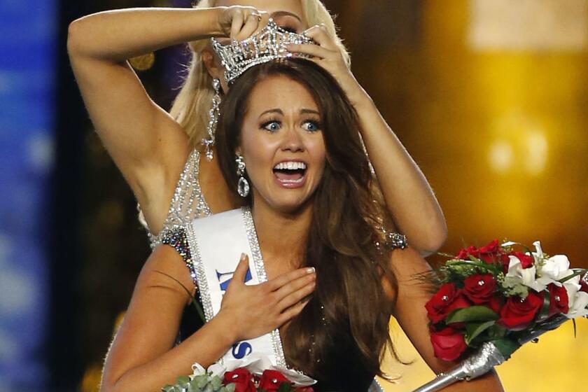 FILE - In this Sunday, Sept. 10, 2017, file photo, Miss North Dakota Cara Mund reacts after being named Miss America during the Miss America 2018 pageant in Atlantic City, N.J. With a revolt underway by state pageant officials _ and without swimsuits _ the Miss America competition begins Wednesday night amid the most turmoil the iconic event has seen in decades. (AP Photo/Noah K. Murray, File)