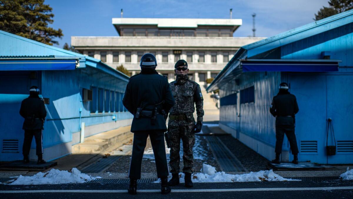 South Korean soldiers stand guard at the border village of Panmunjom in the Demilitarized Zone between South and North Korea on Feb. 7, 2018.