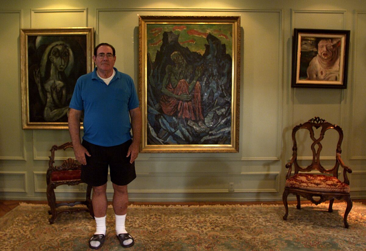 Robert Rifkind in 2008 stands with three of the German Expressionist works he collected.