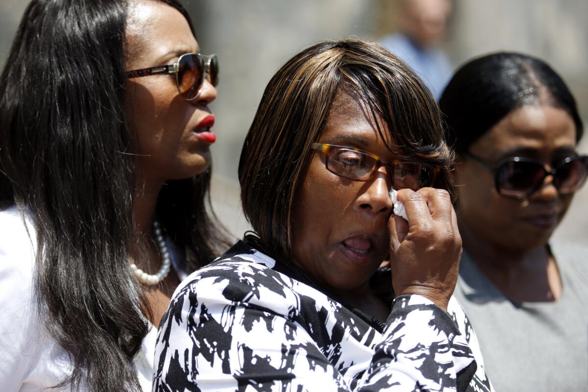 Janet Williams, center, wipes her eyes at a news conference after filing a federal civil rights lawsuit in the death of her son Dennis Williams-Rogers, who was shot by sheriff’s deputies in 2017 in Ladera Heights.
