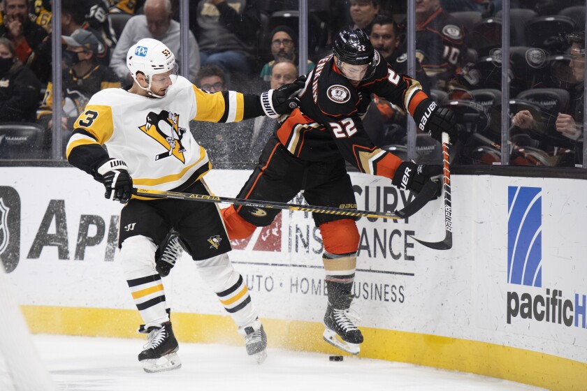 Pittsburgh Penguins center Teddy Blueger (53) checks Anaheim Ducks defenseman Kevin Shattenkirk (22) in the first period of an NHL hockey game in Anaheim, Calif., Tuesday, Jan. 11, 2022. (AP Photo/Kyusung Gong)